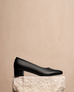 Oya Culford classic black, low heel women's shoes for extended sizes styled shot with shoe on plinth.