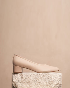 Oya Culford heel, a light blush pink women's low heel made in extended or large shoe sizes, styled photo of shoe on plinth. 