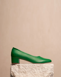 Oya Culford heel in bright emerald green, low heel women's shoes for extended sizes styled shot, shoe on plinth.